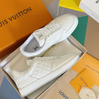 White LV monogram sneakers in box, lace-up uppers and textured rubber midsoles.