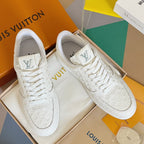 White LV monogram lace-up sneakers pair, with padded collars and rubber soles.
