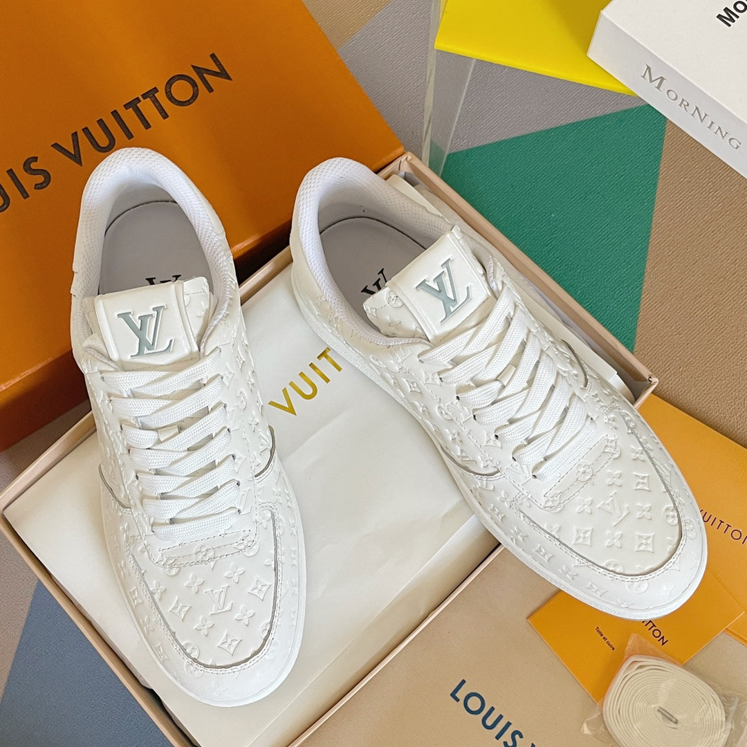 White LV monogram lace-up sneakers pair, with padded collars and rubber soles.