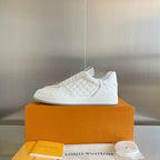 White lace-up sneakers with embossed LV monogram texture and low rubber sole.