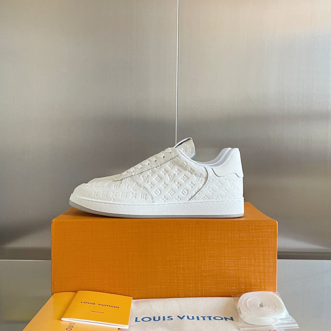 White lace-up sneakers with embossed LV monogram texture and low rubber sole.
