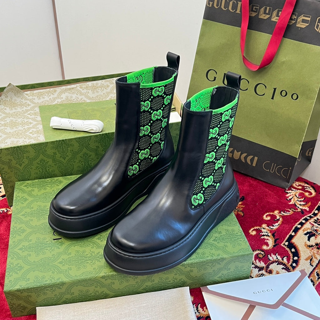 Black Chelsea boots with neon green GG-pattern elastic panels.