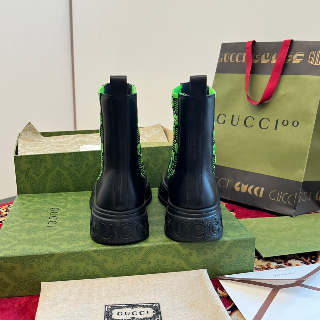 Black Chelsea boots with neon green GG-pattern elastic, rear view.