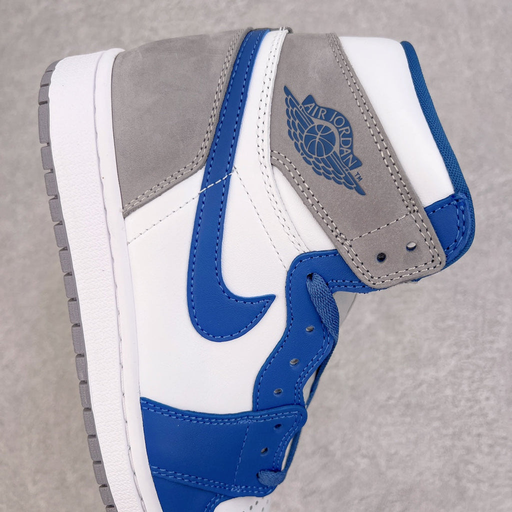 High-top sneaker side view with gray suede, blue Swoosh, and white midsole