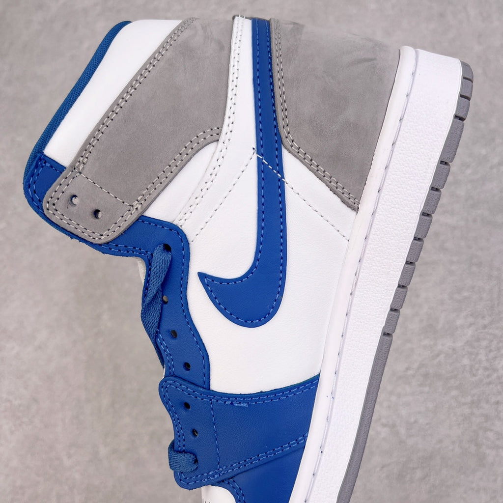 High-top sneaker quarter view with white leather, blue accents, and gray overlay