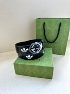 Gucci belt on box set: dark navy leather with white trefoil emblems and metal buckle