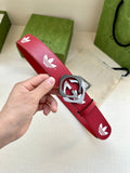 Red leather Gucci belt with white trefoil pattern and round silver-tone logo buckle