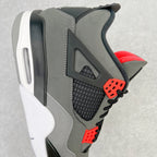 Side view grey sneaker with black mesh panel, red lace eyelets, and white midsole