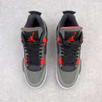 Pair of grey low-top sneakers with black laces, red accents, and white soles