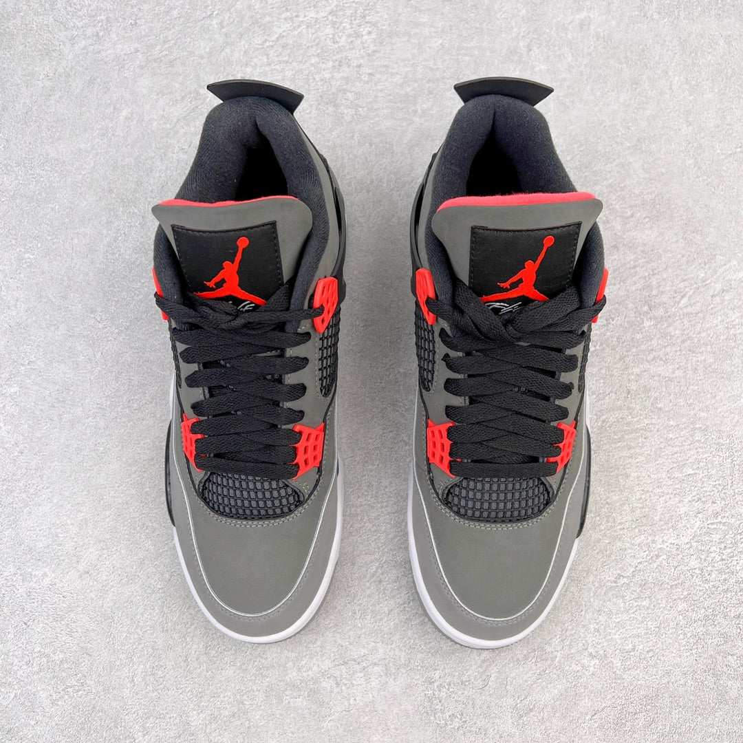 Pair of grey low-top sneakers with black laces, red accents, and white soles