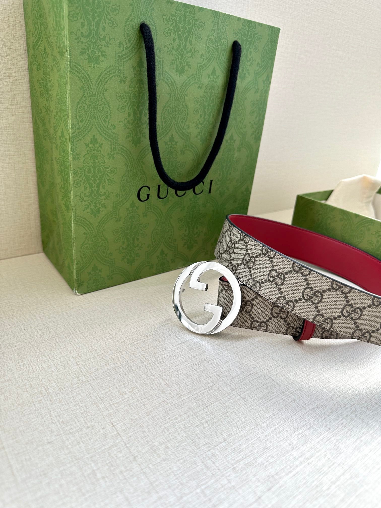 Gucci GG canvas belt with circular silver G buckle and red edge