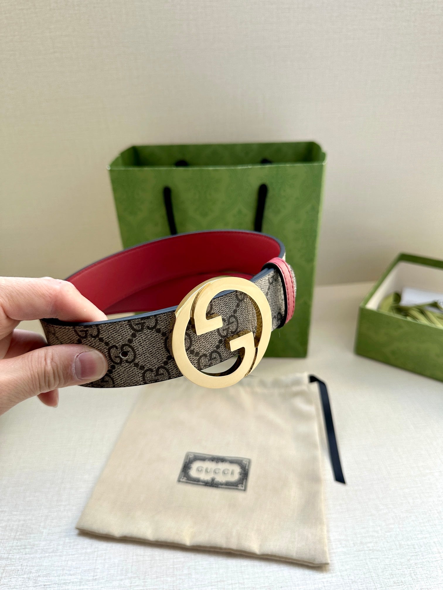 Gucci GG canvas belt with gold G buckle and red leather strap