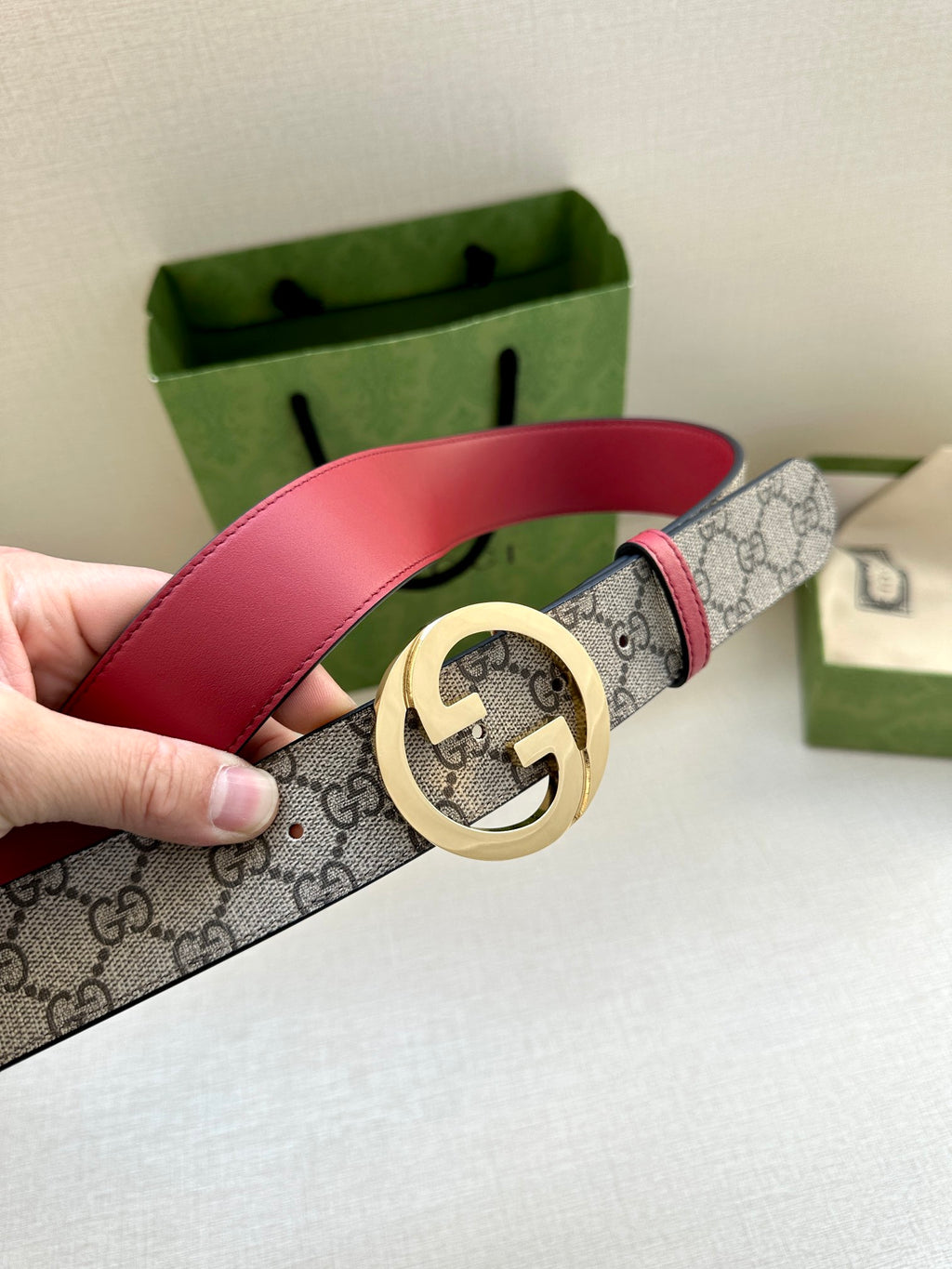 Gucci GG canvas belt with gold-tone G buckle and red leather strap