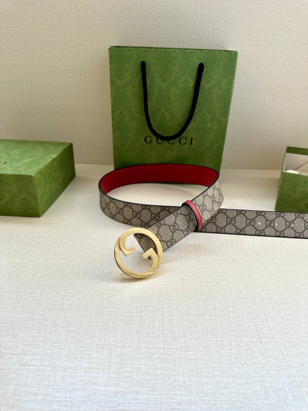 Gucci GG canvas belt with gold G buckle and red leather edge