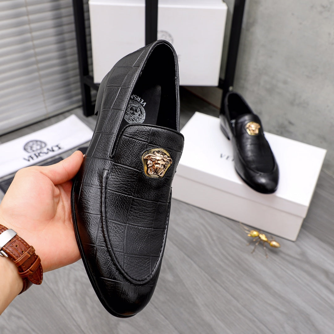 Black leather loafer with gold lion buckle detail on front strap