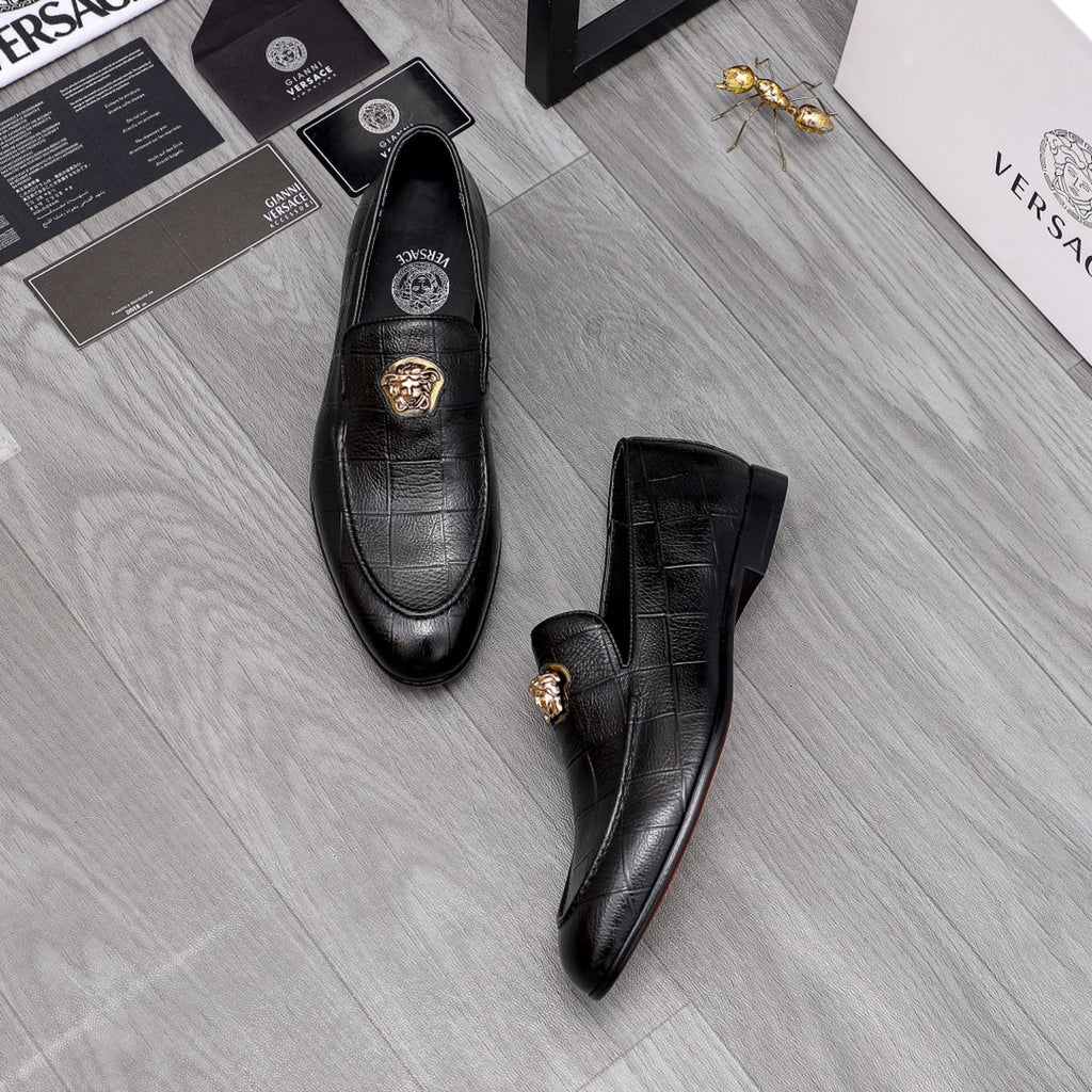 Black leather loafers with gold lion emblem on vamp, side view pair
