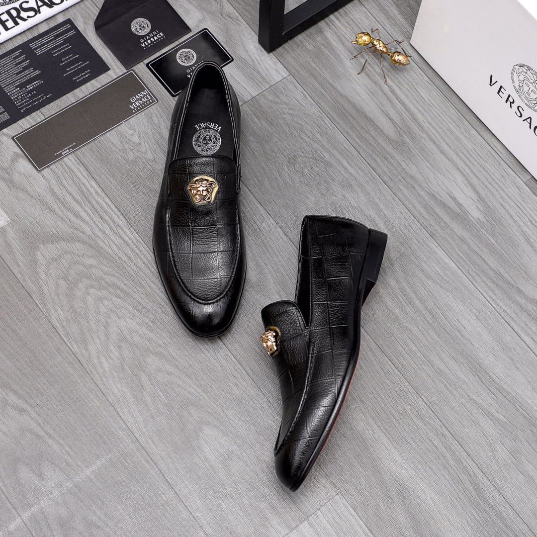 Black leather loafers with gold lion emblem on vamp, side view pair