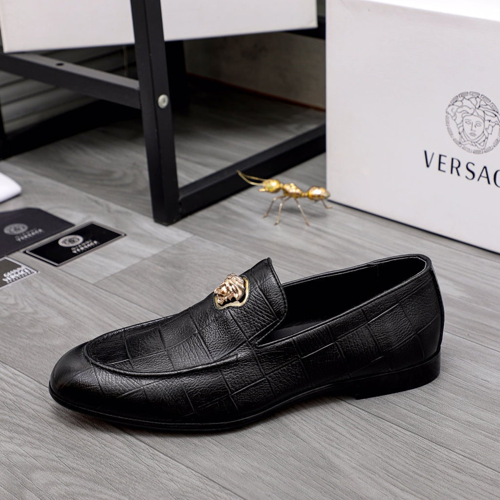 Black leather loafer with gold emblem at vamp and slip-on silhouette