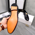 Black leather loafer sole view with tan insole and flat rubber outsole