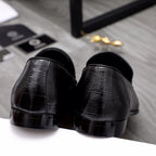 Black leather loafer heels with glossy toe finish and slip-on back