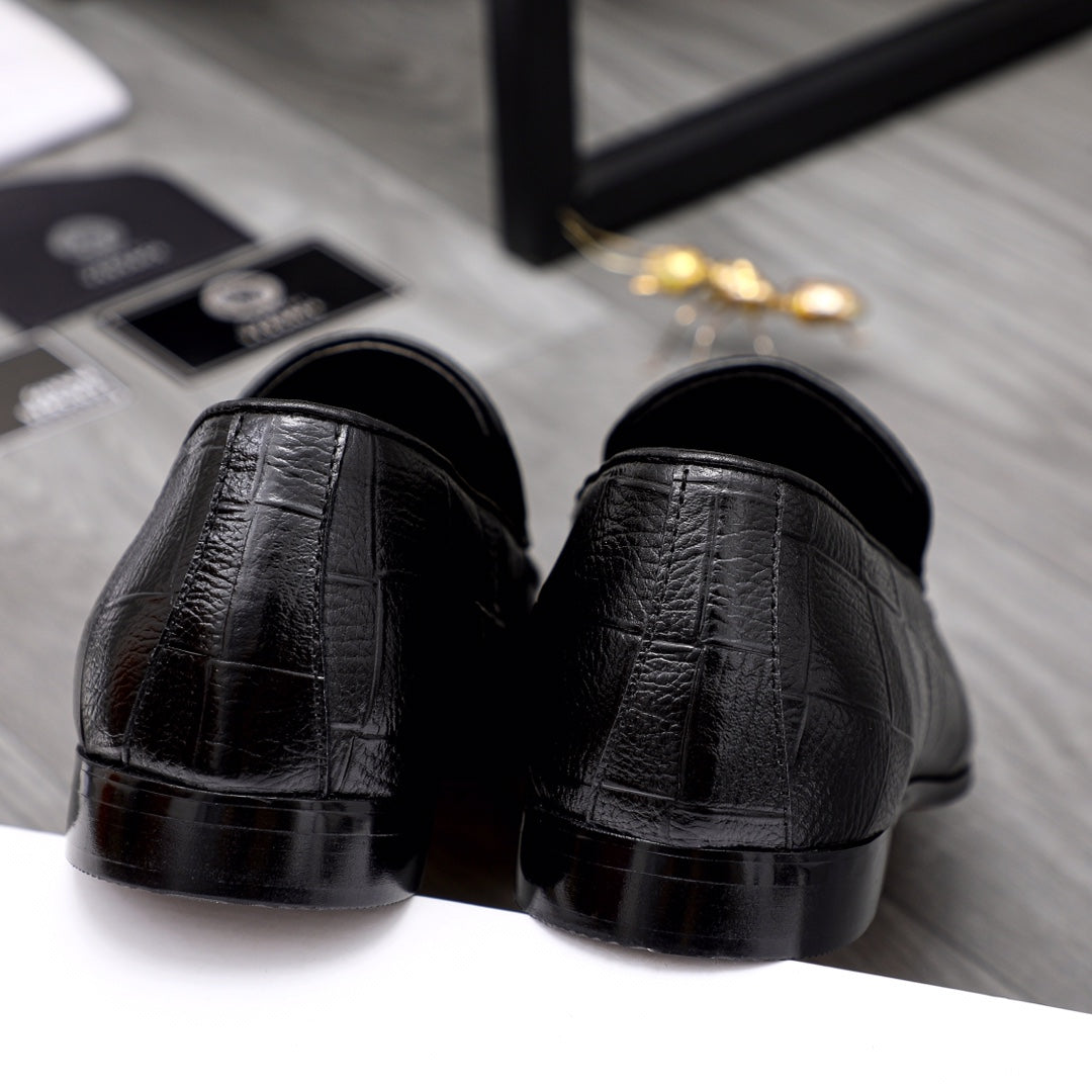 Black leather loafer heels with glossy toe finish and slip-on back