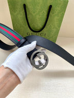 Gucci belt, dark navy strap with multicolor stripe, silver double-G buckle