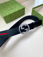 Gucci belt, dark navy leather and multicolor stripe, silver double-G buckle closeup