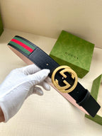 Gucci belt in dark blue leather with gold-tone double-G buckle and green-red stripe web.