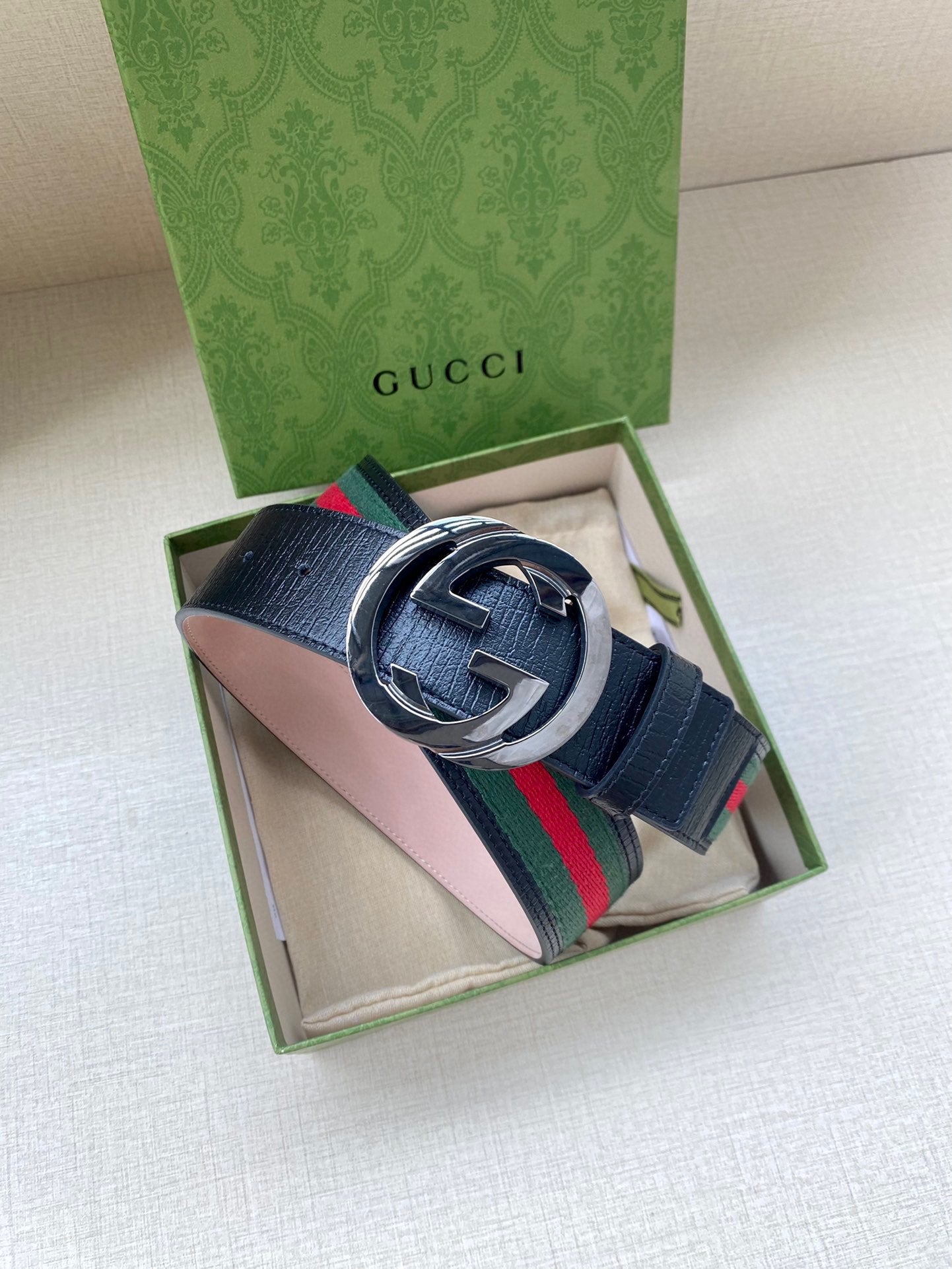 Gucci belt in box: dark blue leather with silver-tone double-G buckle and multicolor stripe.