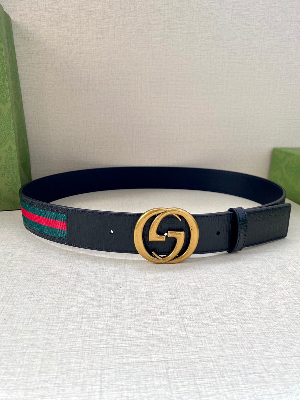Navy leather belt with gold double-G buckle and multicolor striped band