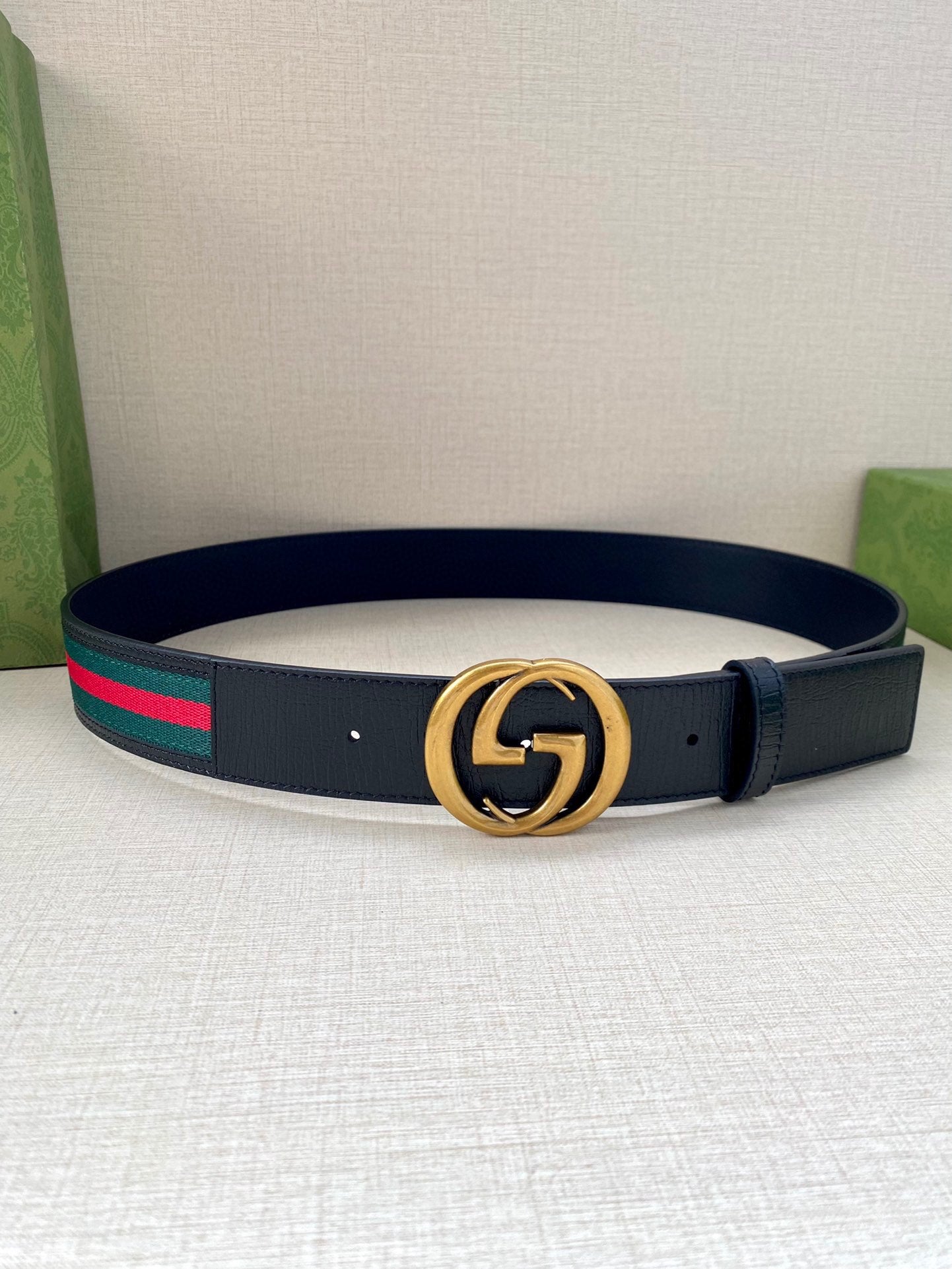 Navy leather belt with gold double-G buckle and multicolor striped band