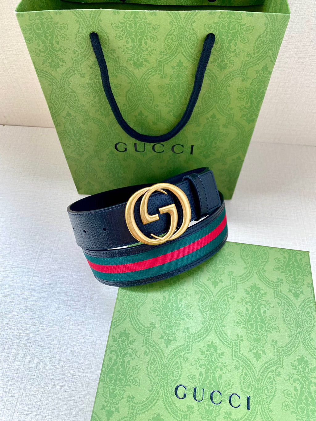 Navy leather belt with gold double-G buckle and multicolor striped band