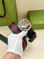 Navy leather belt with striped webbing and silver double-G buckle