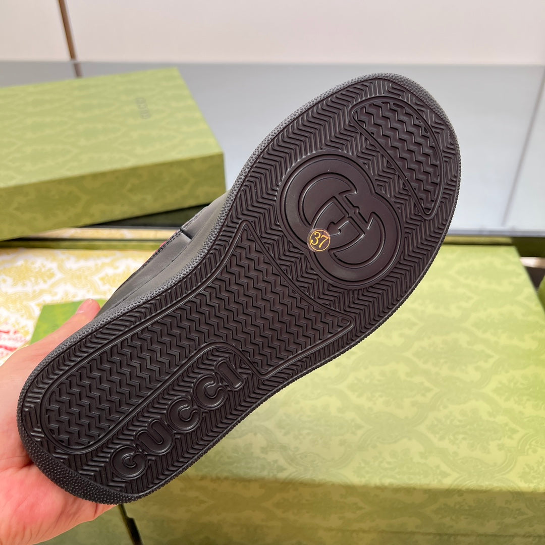 Black rubber boot outsole with textured tread and circular brand logo