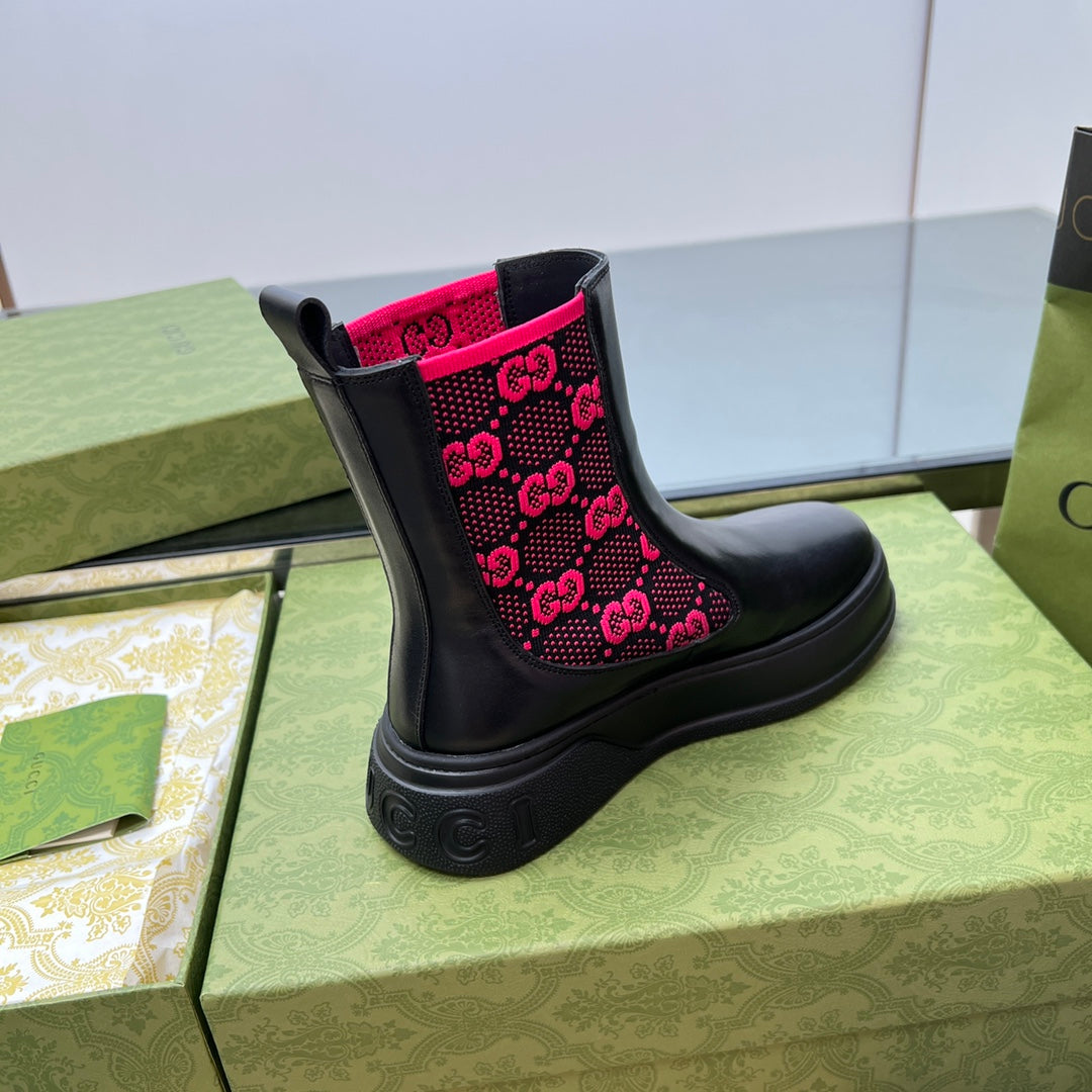 Black unisex chelsea boots with pink GG logo pattern on the side and chunky sole