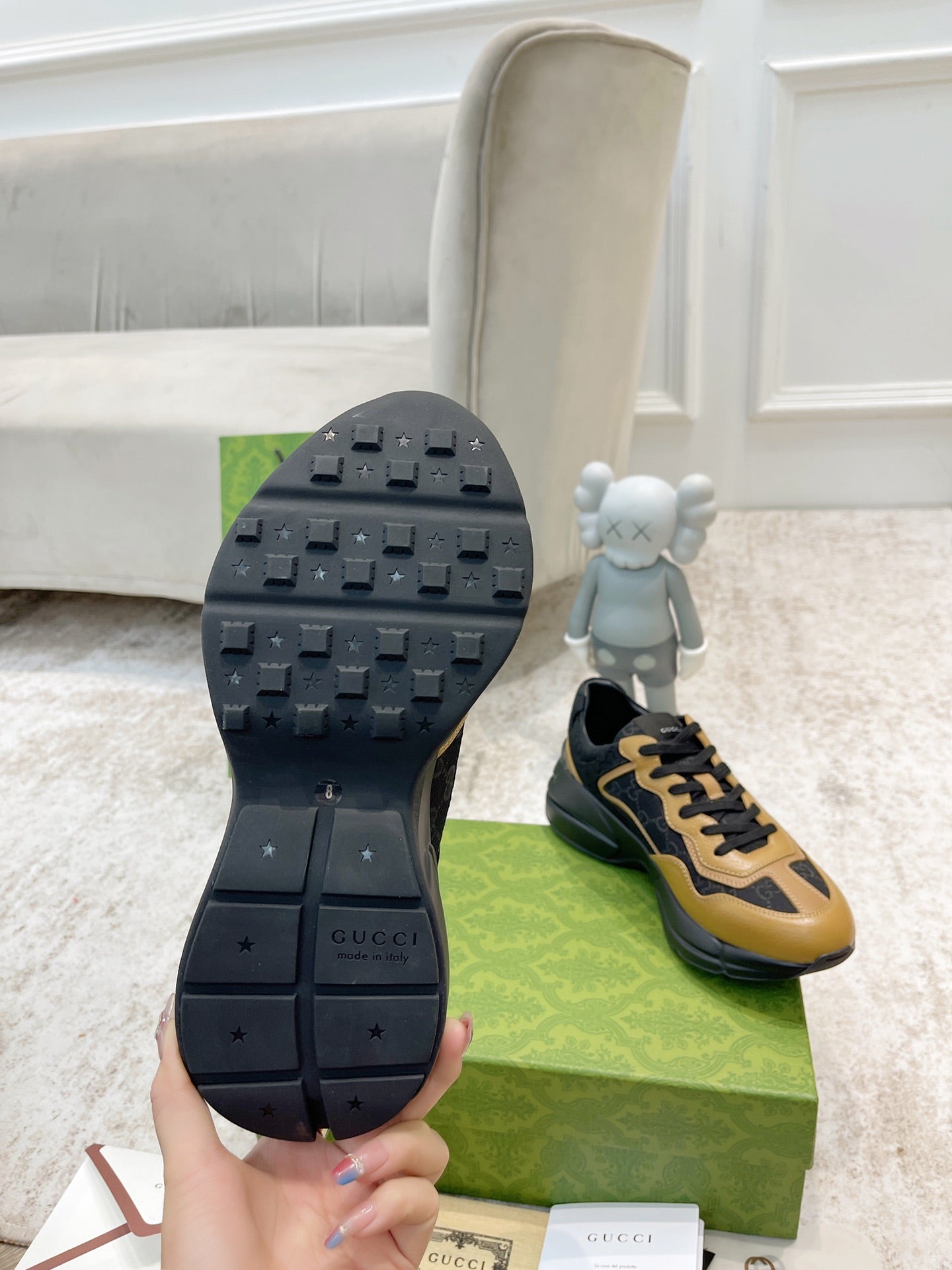 Gucci unisex sneaker outsole and side view, black tread with black-and-tan upper