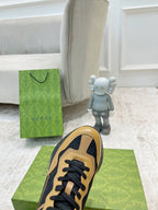Gucci unisex low-top sneaker, tan and black upper with lace-up and toe view