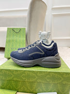 Gucci unisex sneakers in navy blue with chunky gray outsole and lace-up ties.