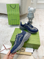Gucci unisex sneakers navy blue with gray tread sole and lace-up front.