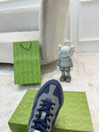 Gucci unisex sneaker upper in navy blue with lace eyelets and gray trim.