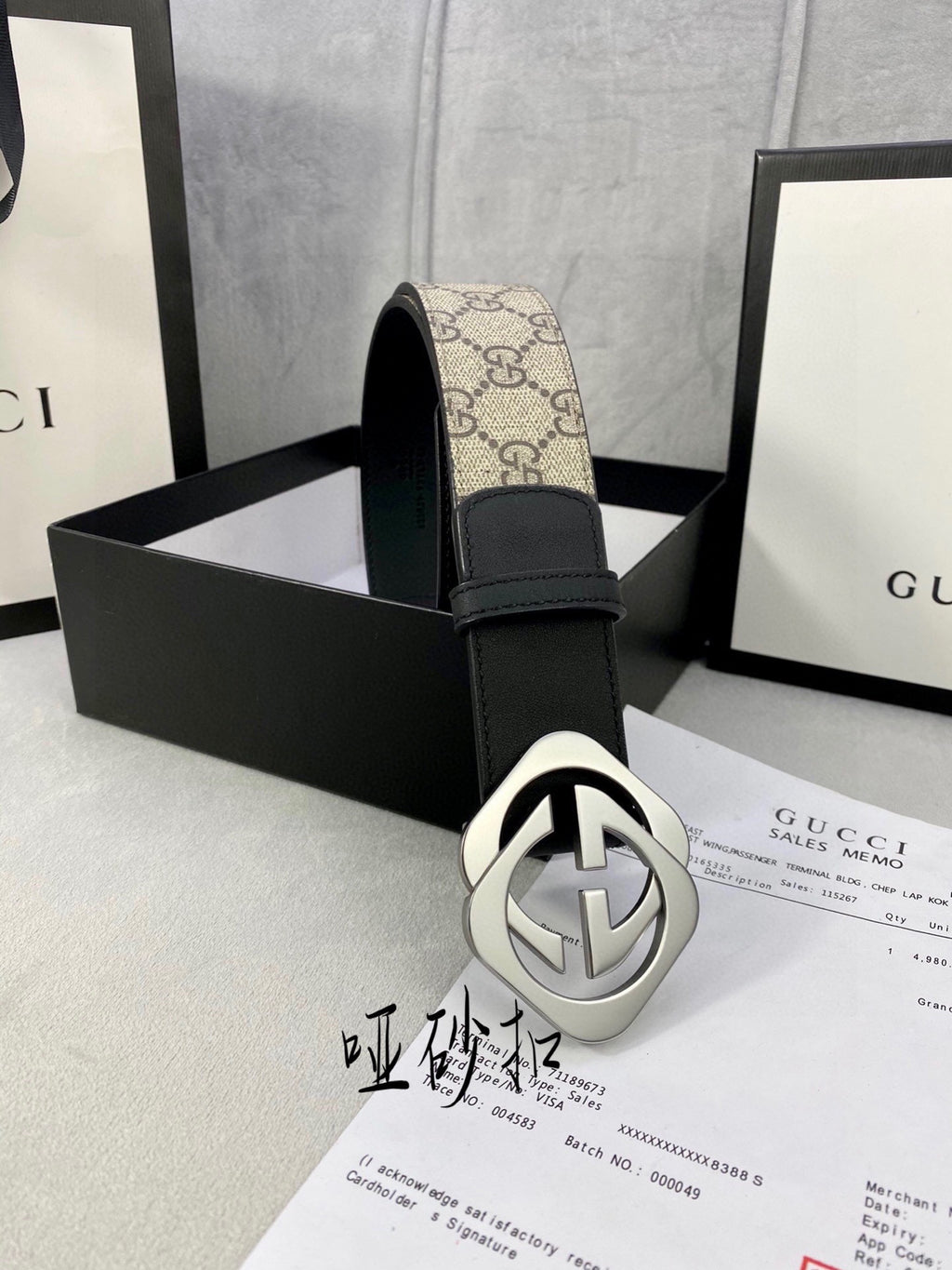 Gucci belt with tan GG canvas strap, black leather trim, and silver-toned GG buckle
