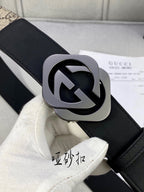 Close-up Gucci belt: black leather strap with silver-toned GG logo buckle