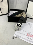 Gucci belt with black leather strap and silver-toned GG buckle, shown with box accessories