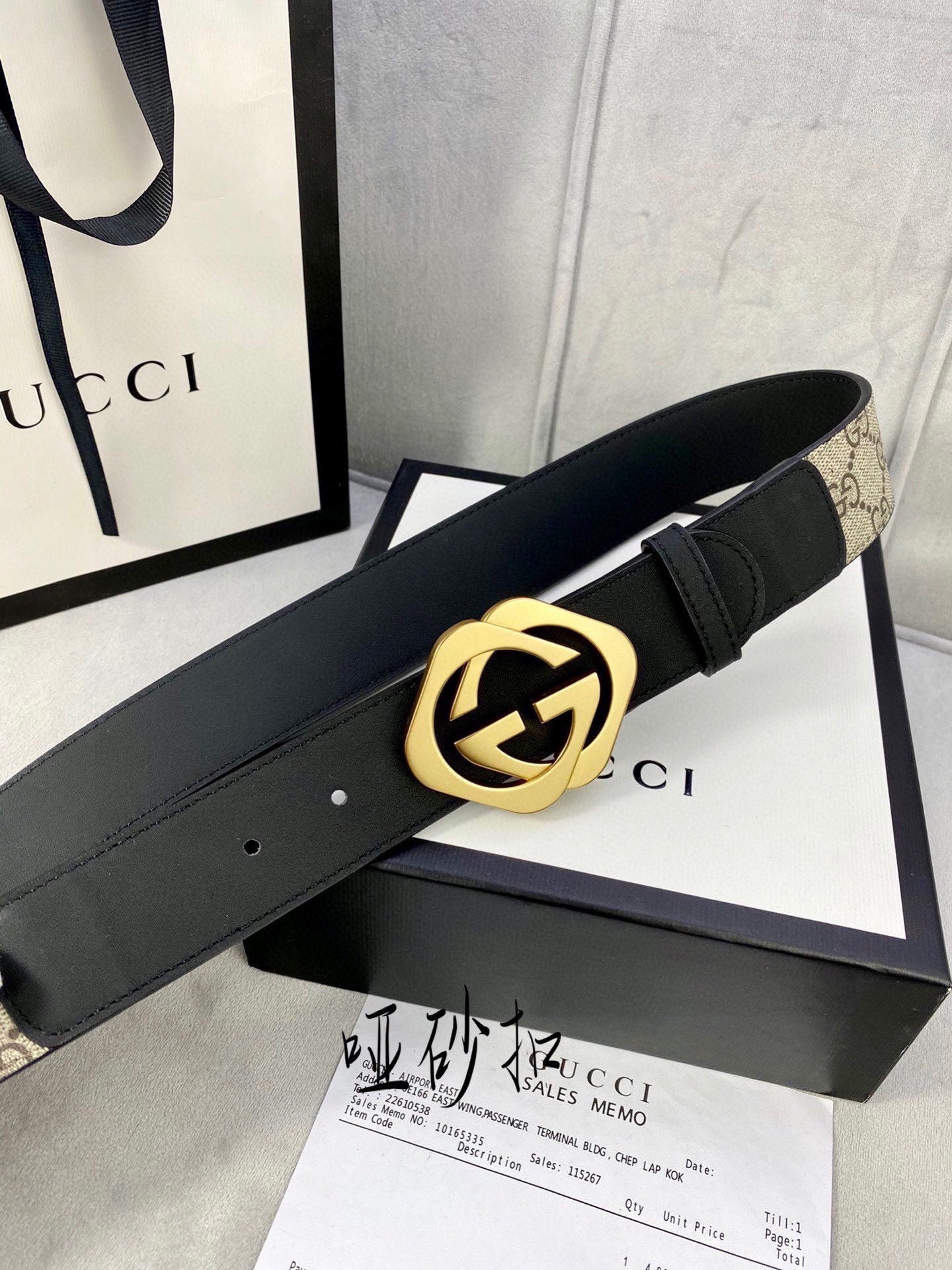 Gucci belt with black leather strap and large gold-toned GG logo buckle