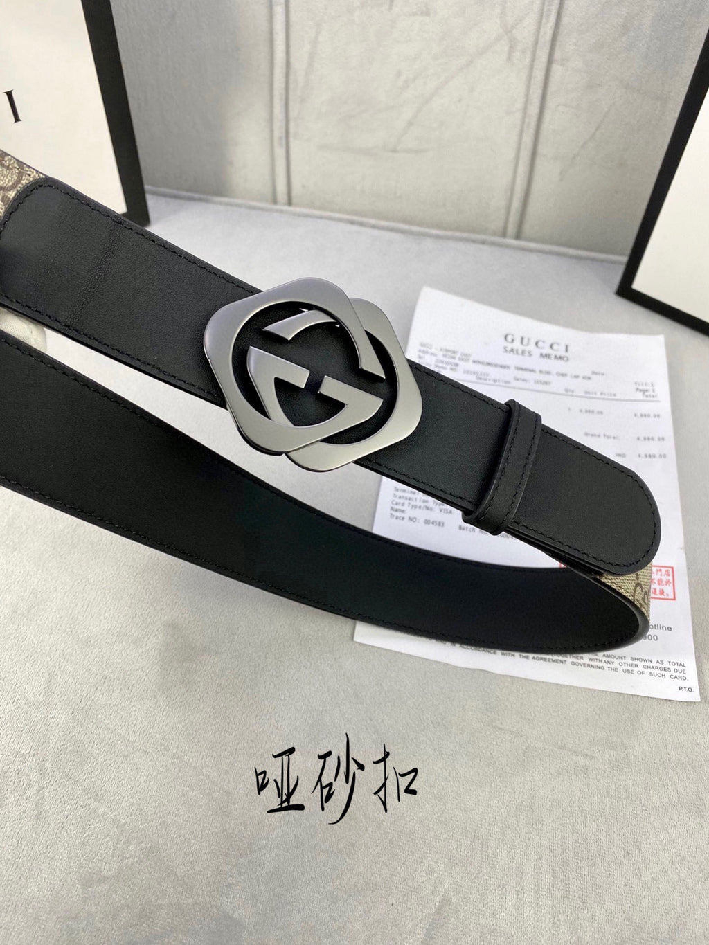 Gucci belt with black leather strap and silver-toned GG logo buckle