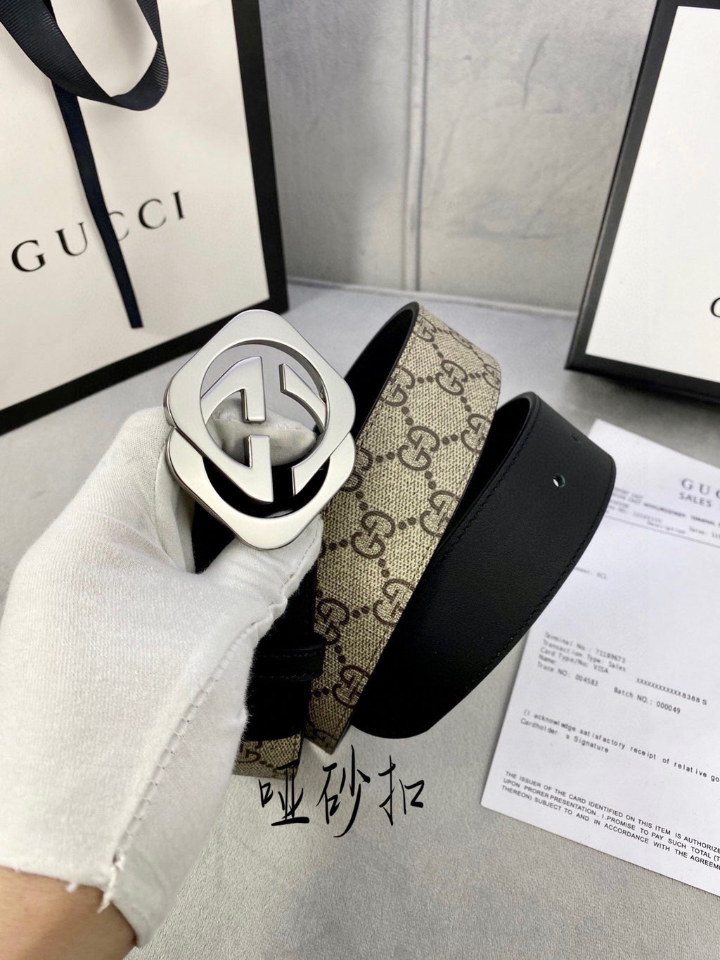 Gucci belt with black leather strap and tan GG canvas backing, silver-toned GG buckle