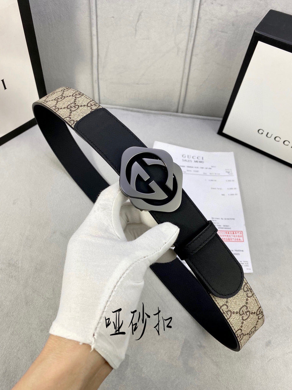 Gucci belt with black leather strap, tan GG canvas panel, and dark-toned buckle
