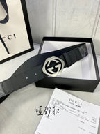 Black Gucci belt with GG monogram strap and round silver-tone GG buckle.
