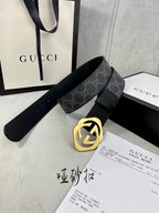 Black Gucci belt with GG monogram strap and gold-tone interlocking buckle.