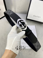 Black Gucci belt with GG monogram strap and silver-tone interlocking buckle.